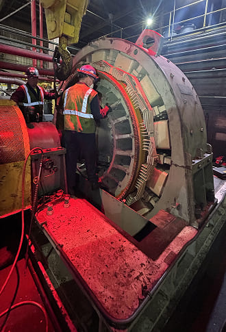 Workers inspecting large machinery