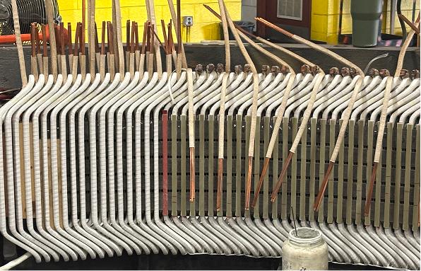 Technician servicing industrial motor in repair shop